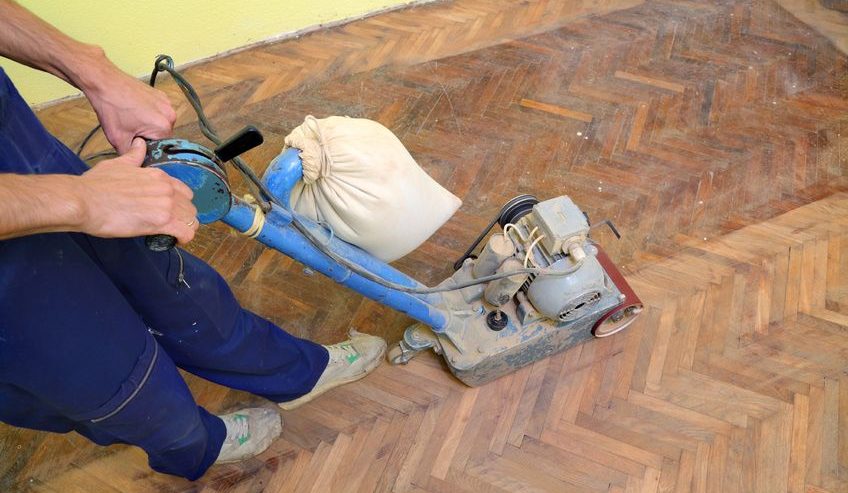 worker polishing old parquet floor